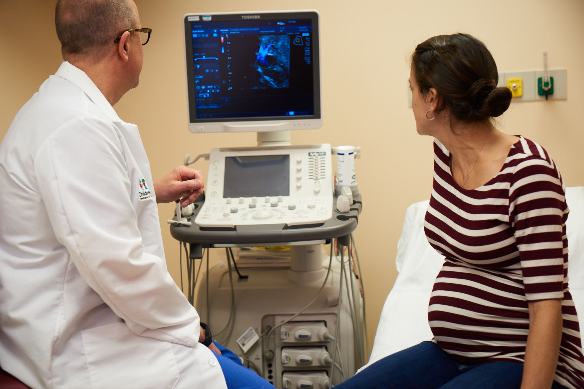 Fetal Cardiologist Reviewing Echocardiogram With Patient